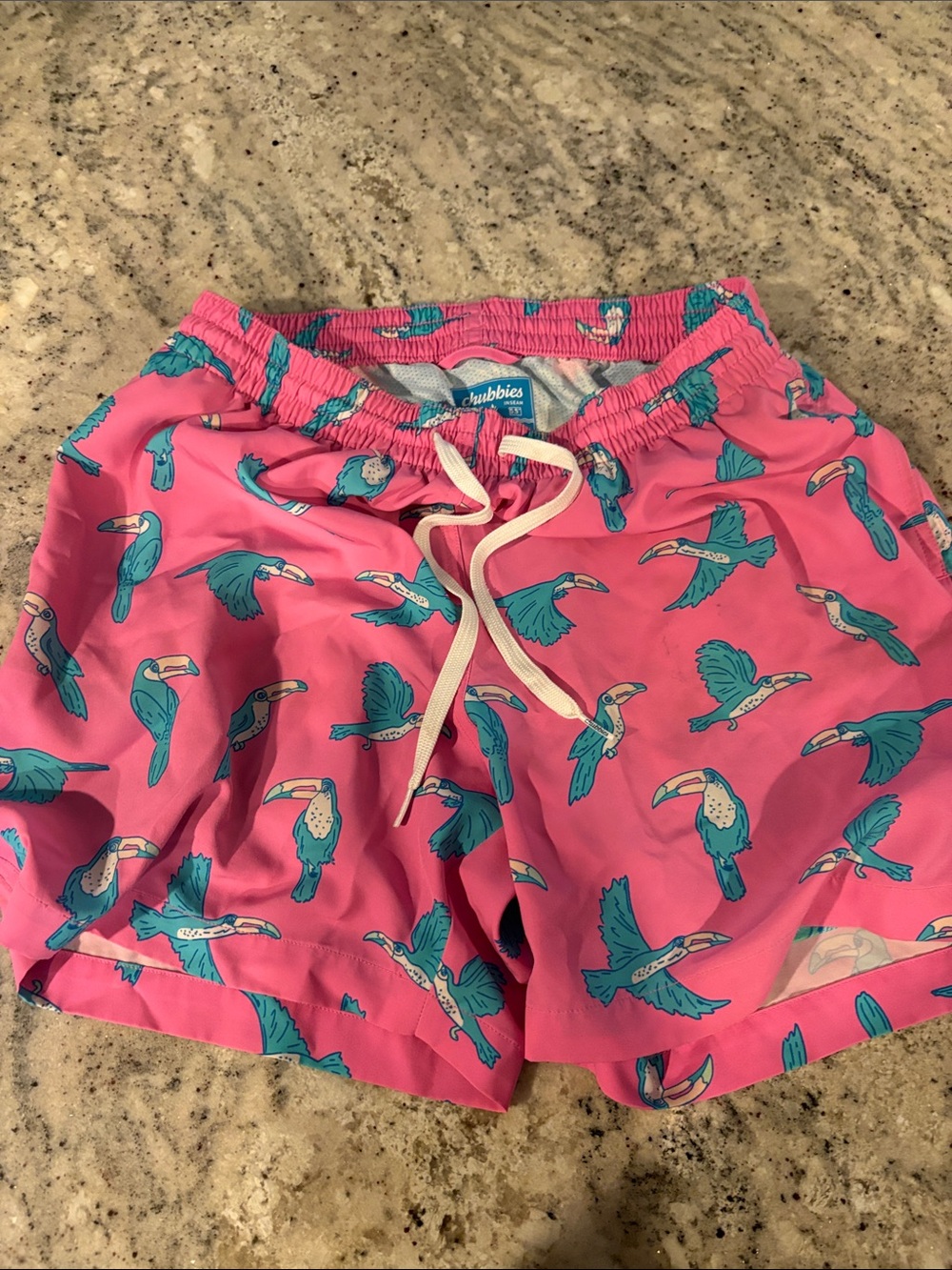 chubbies Men’s Pink Swim Trunks with Teal Toucan Print and boxer liners.